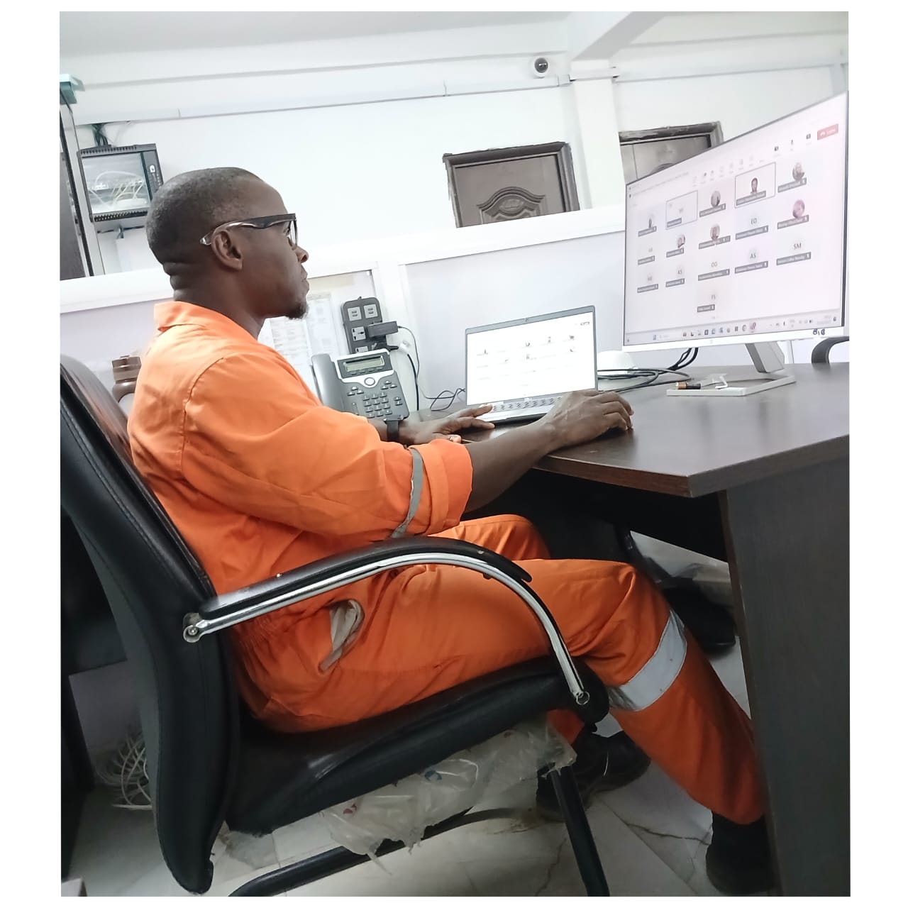 Louis Okperiruisi working at a desk during enterprise IT operations and system monitoring